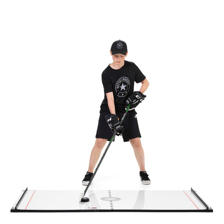 Young hockey player in Better Hockey gear training stickhandling in a focused stance during off-ice practice