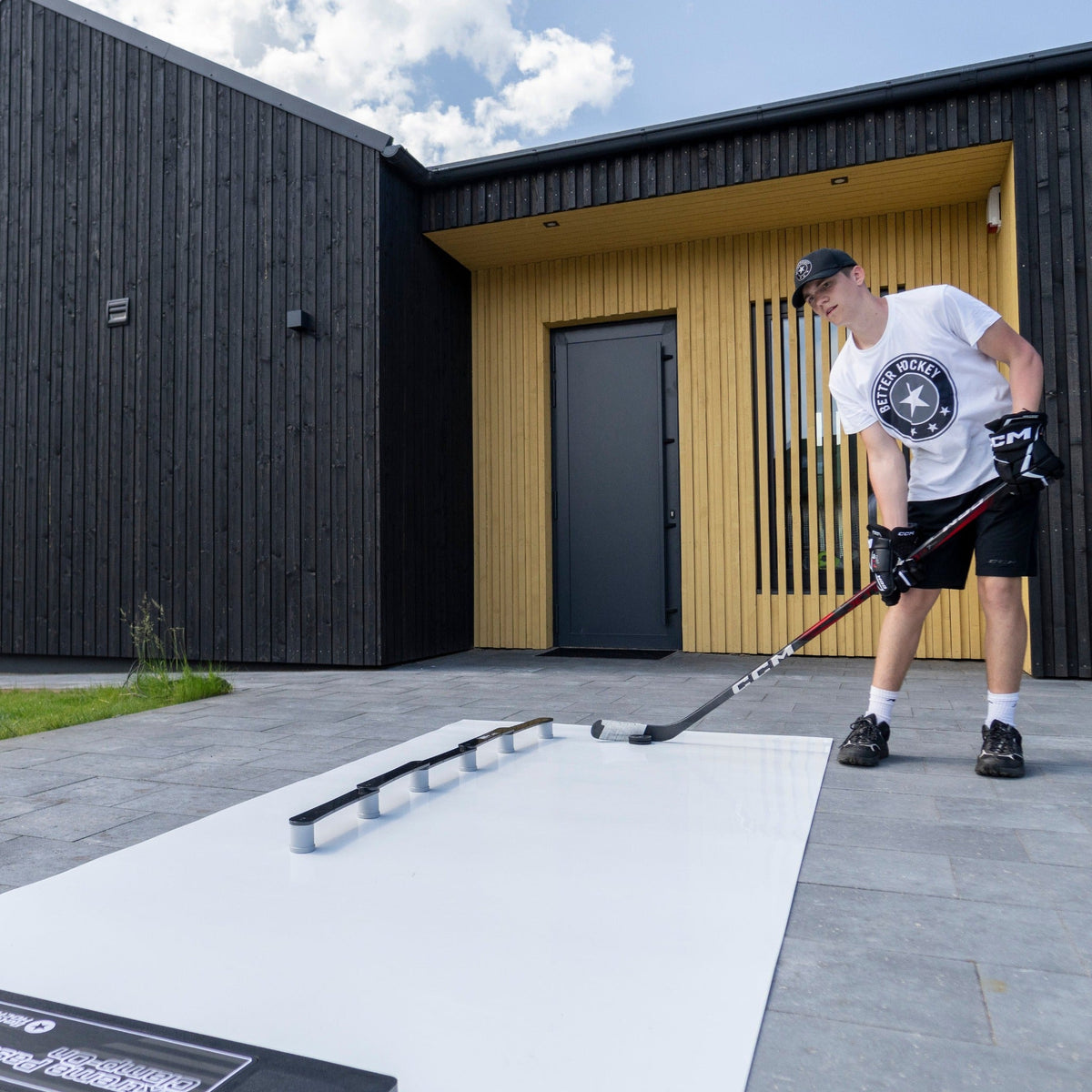 Young hockey player practicing with training gear at home between seasons