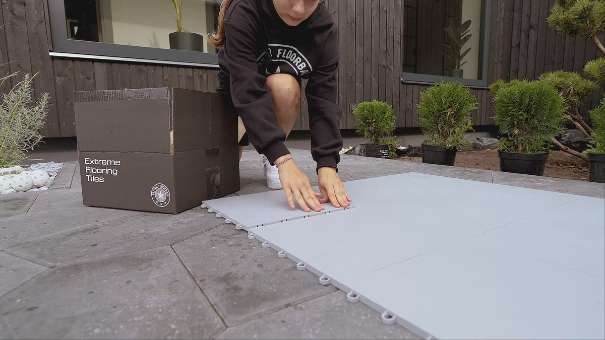Snapping floorball tiles together on a patio